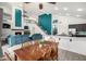 Inviting living area with open kitchen and dining, featuring a fireplace and access to the upper level at 13636 W Calavar Rd, Surprise, AZ 85379