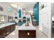 Bright open-concept living area with a modern kitchen, cozy living room, and a staircase at 13636 W Calavar Rd, Surprise, AZ 85379