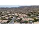 Scenic aerial view of a desert community with homes featuring tile roofs nestled against a mountain backdrop at 14609 S 24Th Way, Phoenix, AZ 85048