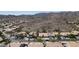 An aerial view of a desert community with homes featuring landscaping and garages and a backdrop of desert mountains at 14609 S 24Th Way, Phoenix, AZ 85048