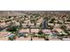 Aerial view highlighting a community of homes with pools, surrounded by lush desert landscaping and mountains in the distance at 14609 S 24Th Way, Phoenix, AZ 85048