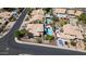 Aerial shot of backyard pools and spas featured in this residential area with beige homes, green trees, and desert landscaping at 14609 S 24Th Way, Phoenix, AZ 85048