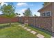 Beautiful backyard featuring lush green grass and charming gabion walls for privacy at 14609 S 24Th Way, Phoenix, AZ 85048