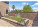 Scenic backyard with rock garden, raised beds, and lush greenery, framed by gabion privacy walls at 14609 S 24Th Way, Phoenix, AZ 85048