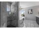 Bright bathroom featuring a glass shower, free-standing tub, marble tile flooring, and modern fixtures at 14609 S 24Th Way, Phoenix, AZ 85048