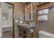 Charming powder room with rustic vanity, decorative mirror, and tiled flooring at 14609 S 24Th Way, Phoenix, AZ 85048