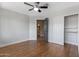 Bedroom with hardwood floors, ceiling fan, closet, and bathroom access at 14609 S 24Th Way, Phoenix, AZ 85048