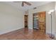 Simple bedroom featuring a ceiling fan, and closet with beautiful doors and rustic hardware at 14609 S 24Th Way, Phoenix, AZ 85048