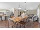 Open-concept dining area featuring an expansive table with seating, tile floors, and views into the living room at 14609 S 24Th Way, Phoenix, AZ 85048