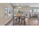 Bright dining area featuring a table with seating, tile floors, pendant lights, and outdoor views including the pool at 14609 S 24Th Way, Phoenix, AZ 85048