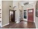 Elegant foyer with beautiful tile flooring, decorative shelving, a stylish light fixture, and a wood door at 14609 S 24Th Way, Phoenix, AZ 85048