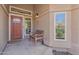 Welcoming front porch with a cozy bench, stylish front door, and views of the well-manicured yard at 14609 S 24Th Way, Phoenix, AZ 85048