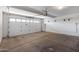 A clean, empty garage with a white door, overhead lighting, and electric vehicle charging outlet at 14609 S 24Th Way, Phoenix, AZ 85048