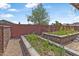 Charming garden area with stone-lined raised beds, vibrant plants, and inspiring wall art at 14609 S 24Th Way, Phoenix, AZ 85048