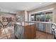 Spacious kitchen featuring an island, stainless steel appliances, and ample natural light from large windows at 14609 S 24Th Way, Phoenix, AZ 85048