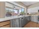 Bright and modern kitchen featuring stainless steel appliances, sleek cabinetry, and a window view of the backyard at 14609 S 24Th Way, Phoenix, AZ 85048