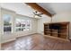 Bright living room featuring a beamed ceiling, tile floor, and natural light from the large windows at 14609 S 24Th Way, Phoenix, AZ 85048