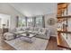 Cozy living room featuring comfortable seating, a large coffee table, decor shelves, and ample natural light at 14609 S 24Th Way, Phoenix, AZ 85048