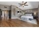 Bright main bedroom featuring hardwood floors, ceiling fan, and decorative accents at 14609 S 24Th Way, Phoenix, AZ 85048