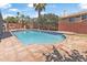 Backyard featuring a refreshing pool with a brick surround and mature landscaping at 14609 S 24Th Way, Phoenix, AZ 85048