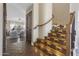 Staircase featuring Saltillo tile flooring, decorative inlays, a wooden railing and dark iron balusters at 14609 S 24Th Way, Phoenix, AZ 85048