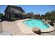 Backyard pool and patio area with tropical landscaping and two-story home at 14770 W Columbine Dr, Surprise, AZ 85379