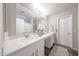 Bathroom featuring double sinks, vanity, a large mirror, and modern finishes at 14770 W Columbine Dr, Surprise, AZ 85379