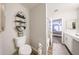 Bathroom with modern shelving, a clean toilet, and a view into the bedroom at 14770 W Columbine Dr, Surprise, AZ 85379