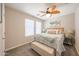 Bedroom featuring a stylish ceiling fan, two windows, and tasteful decor at 14770 W Columbine Dr, Surprise, AZ 85379