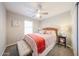 Well-lit bedroom with a ceiling fan, carpeted floors, and neutral décor at 14770 W Columbine Dr, Surprise, AZ 85379