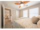 Light-filled bedroom with cozy carpet, a stylish ceiling fan, and an ensuite entrance at 14770 W Columbine Dr, Surprise, AZ 85379