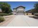 Charming two-story home featuring a well-manicured front yard and inviting curb appeal at 14770 W Columbine Dr, Surprise, AZ 85379
