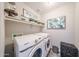 Functional laundry room featuring a Samsung washer and dryer, decor, and storage at 14770 W Columbine Dr, Surprise, AZ 85379