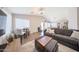 Inviting open-concept living space with wood floors, vaulted ceiling, a cozy seating area, and dining at 14770 W Columbine Dr, Surprise, AZ 85379