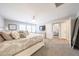 Bright main bedroom featuring a view into the additional bedroom and lots of decor at 14770 W Columbine Dr, Surprise, AZ 85379