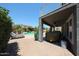 Covered patio overlooking backyard pool and deck with tropical landscaping at 14770 W Columbine Dr, Surprise, AZ 85379