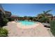 Backyard with swimming pool, lush plants, patio, and outdoor lounge chairs at 14770 W Columbine Dr, Surprise, AZ 85379