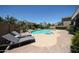 Backyard pool with lounge chairs and well maintained tropical landscaping at 14770 W Columbine Dr, Surprise, AZ 85379