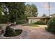 Serene backyard with stone patio, lush greenery, and a tiered water fountain feature at 1522 W Myrtle Ave, Phoenix, AZ 85021