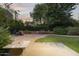 Relaxing backyard oasis with a stone patio, lush greenery, and charming seating area at 1522 W Myrtle Ave, Phoenix, AZ 85021