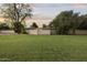 Large backyard with mature trees and expansive grass, ideal for outdoor recreation at 1522 W Myrtle Ave, Phoenix, AZ 85021