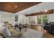 Basement living area with wood ceilings, recessed lighting, sofa, and easy access to the backyard at 1522 W Myrtle Ave, Phoenix, AZ 85021