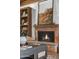Close up on the fireplace with mantle, decor, and a built-in bookshelf at 1522 W Myrtle Ave, Phoenix, AZ 85021
