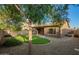 Backyard featuring trees, a lush green grass area and a covered patio at 15674 W Mackenzie Dr, Goodyear, AZ 85395