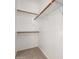 A walk-in closet featuring carpet and storage shelves at 15674 W Mackenzie Dr, Goodyear, AZ 85395