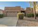 Charming single-story home featuring a well-manicured front yard and a two-car garage at 15674 W Mackenzie Dr, Goodyear, AZ 85395