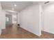 Bright hallway with tile floors leading to an open living area at 15674 W Mackenzie Dr, Goodyear, AZ 85395