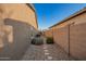 Side yard with gravel, stepping stones, and plants at 15674 W Mackenzie Dr, Goodyear, AZ 85395