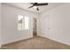Bright bedroom featuring neutral carpet, a ceiling fan, and an adjacent bathroom at 162 N Hunt W Dr, Mesa, AZ 85203
