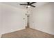Bedroom with ceiling fan, neutral carpet, and doorway to another bedroom at 162 N Hunt W Dr, Mesa, AZ 85203
